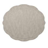 The Kim Seybert Tailored Placemat Gray Set of 4 features a matte faux leather finish, wavy edges with scalloped detailing, and a thin decorative rim line, shown here against a white background.