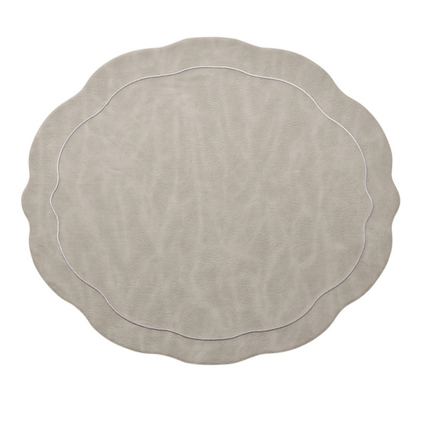 The Kim Seybert Tailored Placemat Gray Set of 4 features a matte faux leather finish, wavy edges with scalloped detailing, and a thin decorative rim line, shown here against a white background.