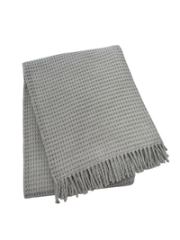 The A Soft Idea Basic Waffle Throw is a folded light gray cotton-acrylic blanket with a waffle pattern and fringed edges, shown on a white background.
