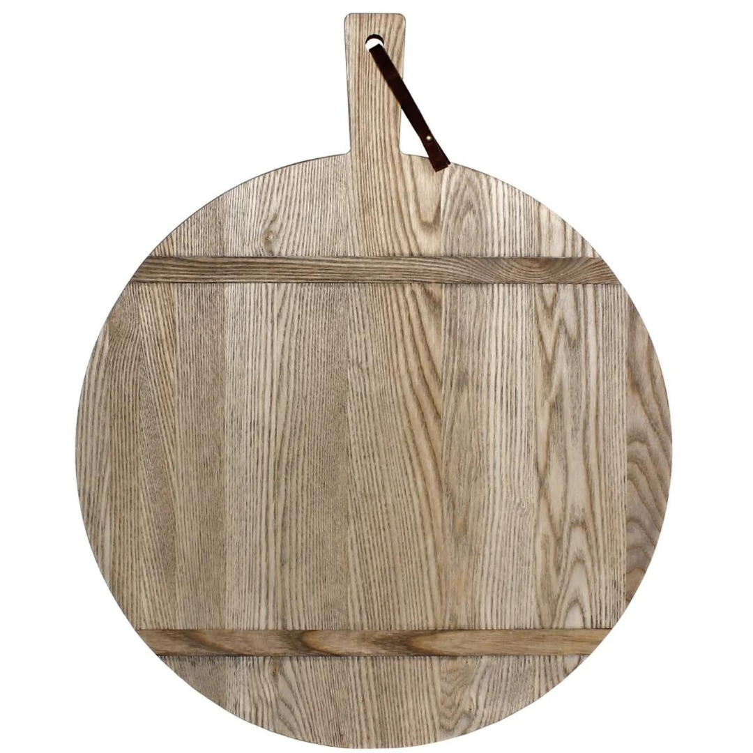 The JK Adams Ash Driftwood Round Serving Board is crafted from ash wood with a natural grain, two support slats, and a handle with dark leather loop—finished in driftwood for rustic charm.
