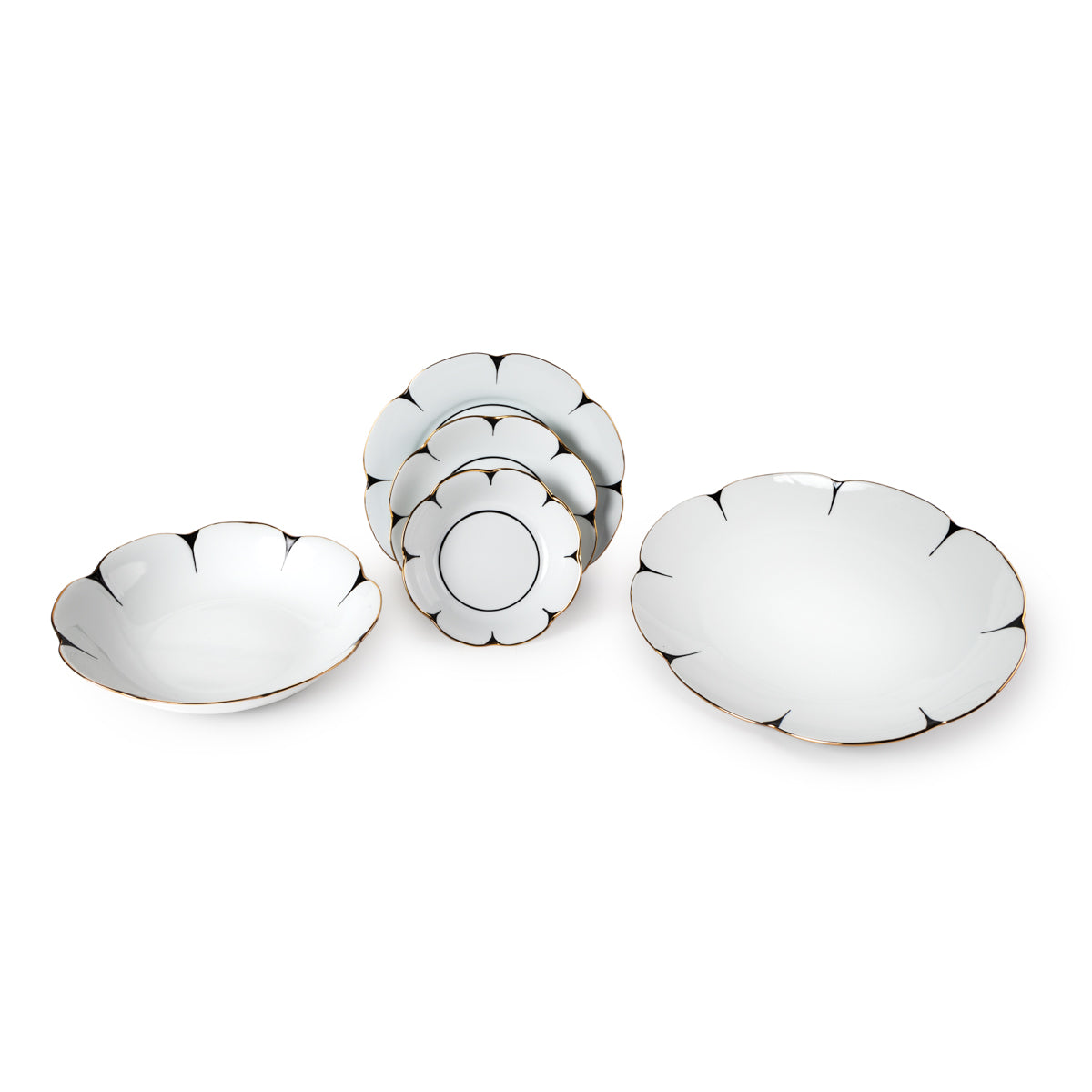 The Molecot Drops Dinnerware set features elegant white ceramic dishes with scalloped edges and gold trim, including two large bowls and three smaller plates stacked vertically.