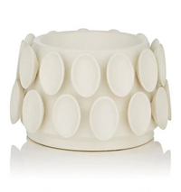 The KleinReid Cumulus Collection Alabaster bracelet features a white, cylindrical form with two rows of evenly spaced, raised ovals reminiscent of handcrafted vase textures, shown against a plain white background.