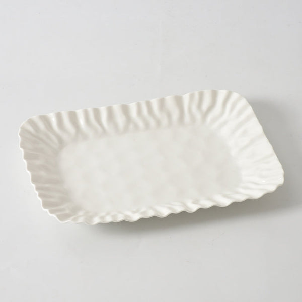 The PAMPA BAY Mascali Bianca Deep Tray is a rectangular white porcelain serving tray featuring wavy, textured edges, shown against a plain white background.