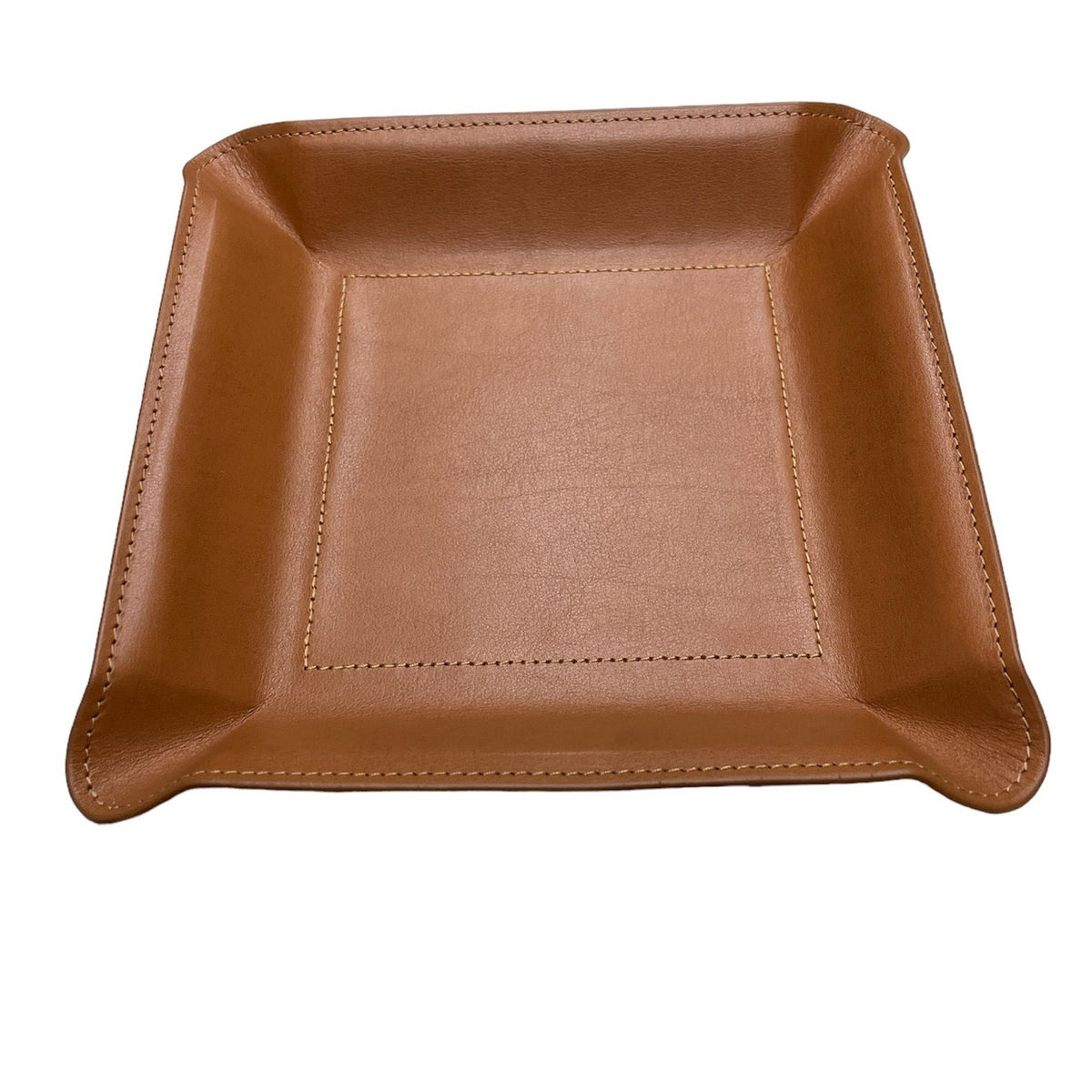 The Graphic Image Leather Valet Tray Medium is a square, light brown leather organizer with raised edges and visible stitching, perfect for men's nightstands. Shown on a white background.
