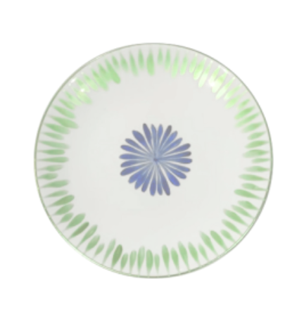 The Marie Daâge Allee de Cypres 4, a luxury white ceramic plate by Marie Daâge, features a central blue floral motif and a green leaf-patterned rim—an elegant addition to any table setting.