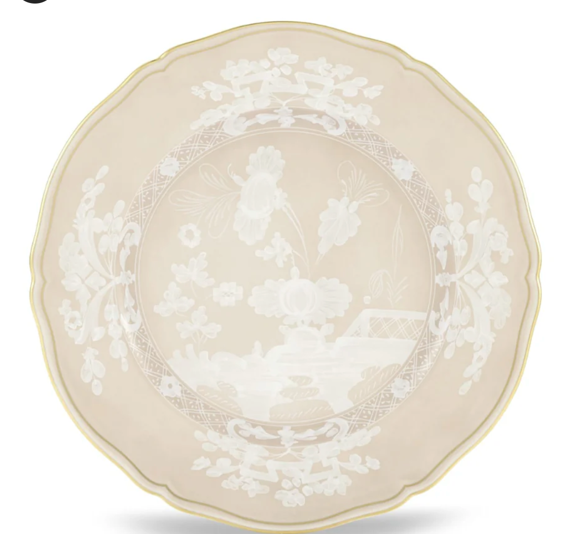 The Oriente Italiano Beige Meringa plate by Ginori 1735 features a scalloped porcelain design in beige with a gold rim and detailed white floral and landscape motifs at the center and border.