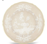 The Oriente Italiano Beige Meringa plate by Ginori 1735 features a scalloped porcelain design in beige with a gold rim and detailed white floral and landscape motifs at the center and border.