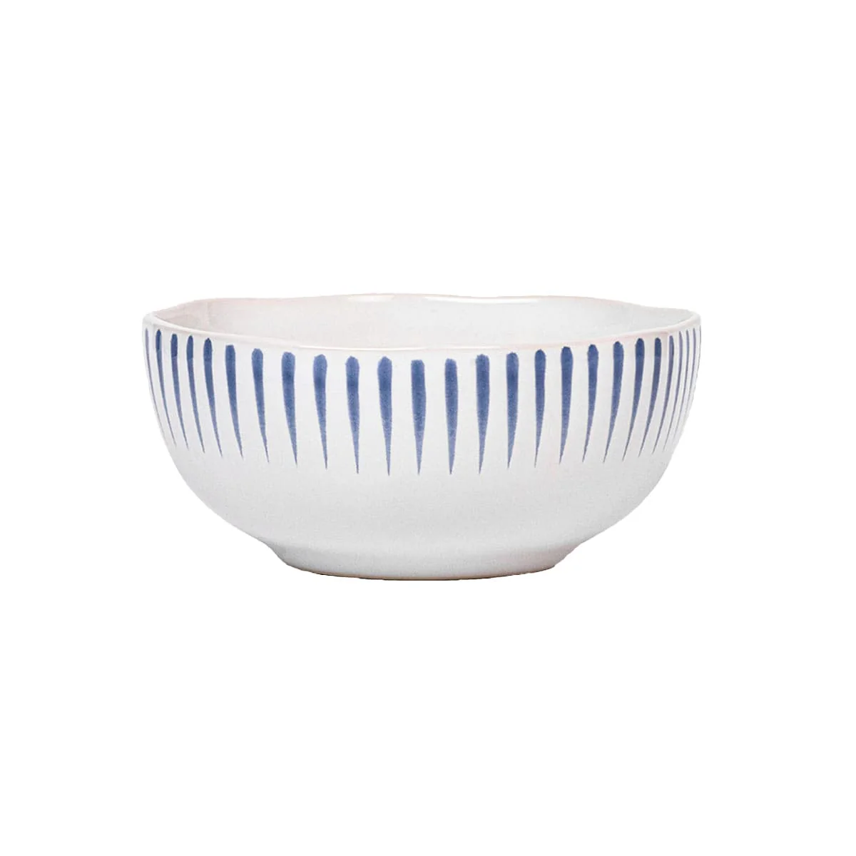 The Juliska Sitio Stripe Dinnerware features a white ceramic bowl with a gently wavy rim and evenly spaced vertical Delft blue lines, finished in a crisp whitewash glaze.