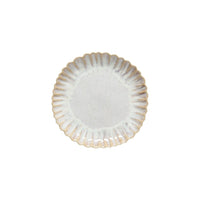 The Casafina Mallorca Dinnerware is a round stoneware plate with a scalloped edge and light speckled glaze, handcrafted and shown from above against a white background.