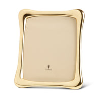 The Anton Frame Gold by L'Objet features softly curved edges and a reflective gold finish, with a blank interior except for the L’Objet logo, making it perfect for displaying your cherished memories.