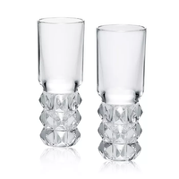 The Louxor Vodka Set of 2 by Baccarat features clear glass tumblers with smooth rims and diamond-cut crystal bases, displayed side by side on a white background.