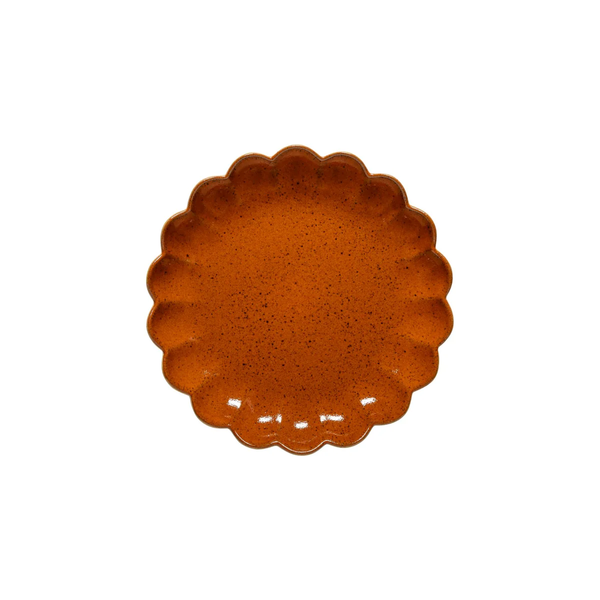 The Costa Nova Marrakesh Dinnerware Orange plate has a round, scalloped flower-like edge, a speckled pattern, and is crafted from recycled clay; it’s shown against a white background.