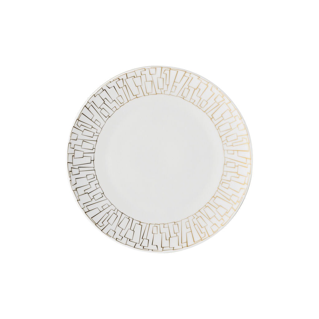 The Rosenthal Tac Skin Gold Dinnerware features a white plate with an intricate gold geometric rim. Its durable glaze enhances color and makes it dishwasher-safe, while the center remains plain for everyday elegance.