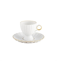 The Vista Alegre 200 Anos Dinnerware features a white porcelain teacup with a hand-painted gold rim and handle on a matching scalloped saucer edged in gold, showcasing modern elegance against a white background.