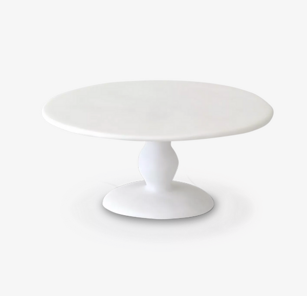 The TF Pedestal Cake Stand White - Large by Tina Frey features a smooth, round surface and a single curved pedestal base, shown against a plain white background.