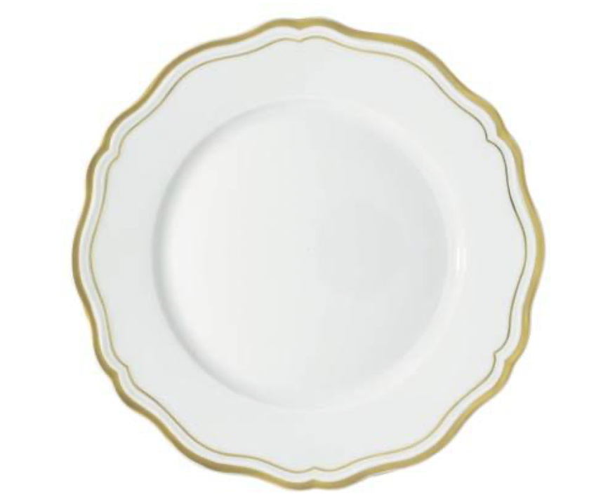The Raynaud Polka Gold Dinnerware features a white scalloped plate with a gold rim, perfect for elevating your tableware.