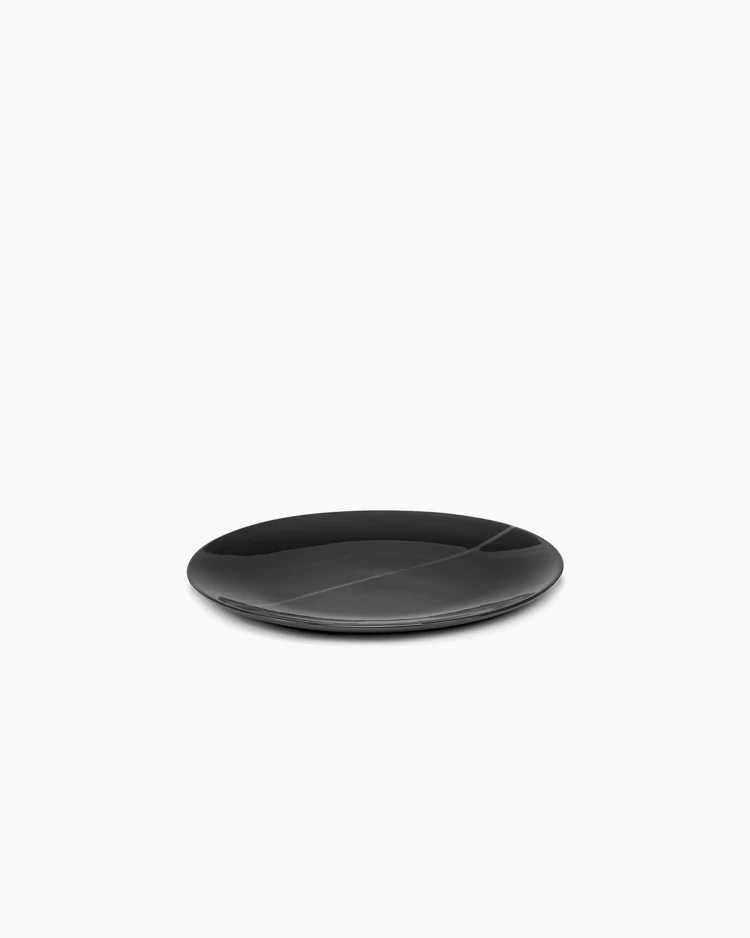 A simple, round, black Serax Zuma Dinnerware Pacific plate is centered on a plain white background.