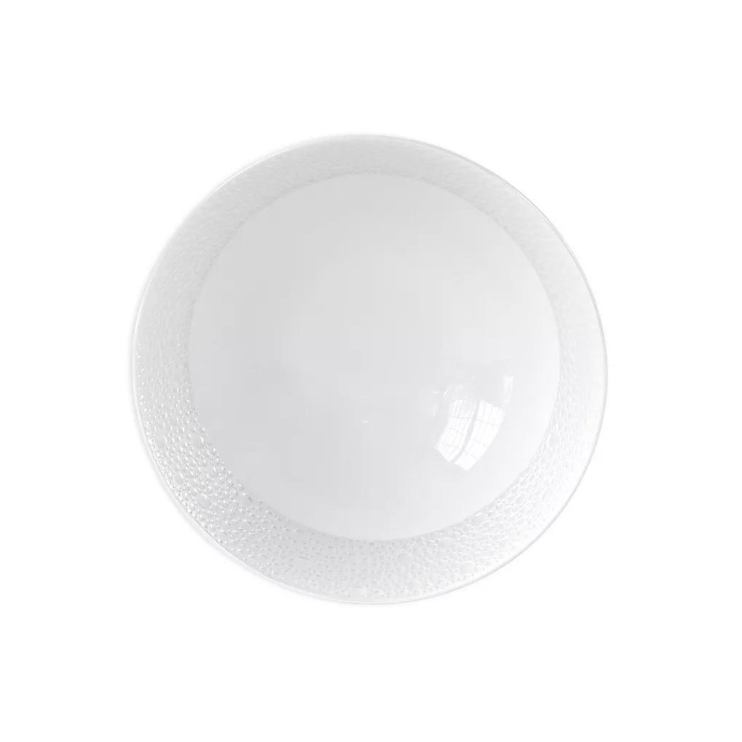 The Bernardaud Ecume Dinnerware Perle plate is round, white ceramic with a subtle rim texture and a refined mother-of-pearl finish, shown from above on a plain white background.
