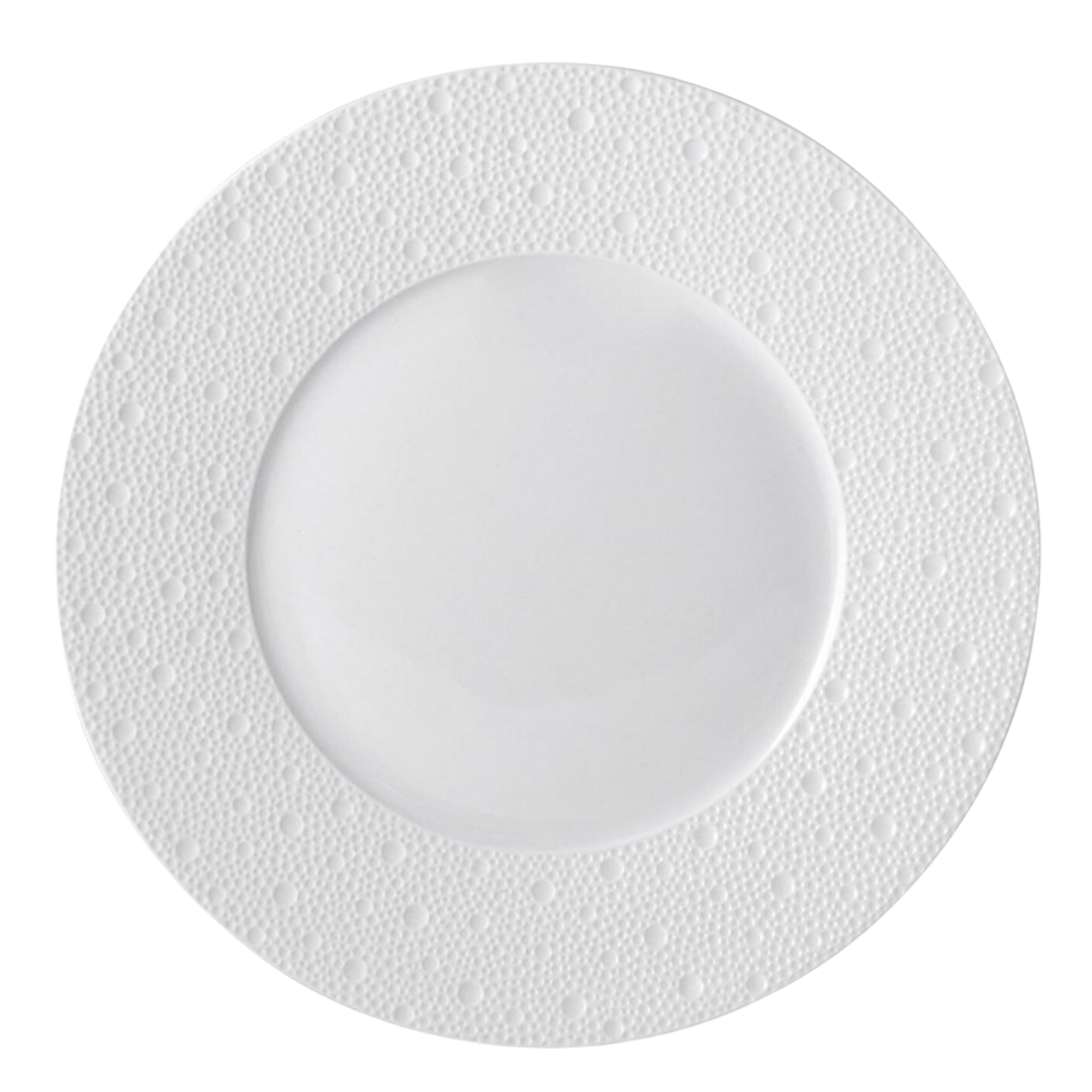 The Bernardaud Ecume White Dinnerware plate features a textured, dotted pattern on its rim and is shown from above against a white background.