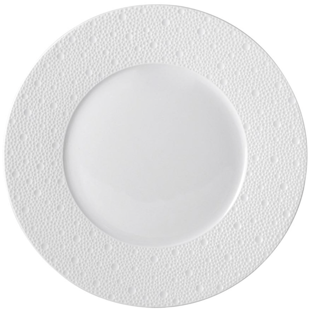 The Ecume White Dinnerware by Bernardaud is a round porcelain plate featuring a smooth center and a dotted, textured rim, shown from above against a plain white background.