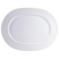 The Ecume White Dinnerware oval platter by Bernardaud is made in France with a subtly textured, dotted rim. Shown on a white background.