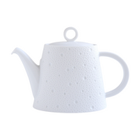 The Ecume White Dinnerware teapot by Bernardaud features Limoges porcelain with a dotted texture, round handle, curved spout, and a lid topped with a circular knob.