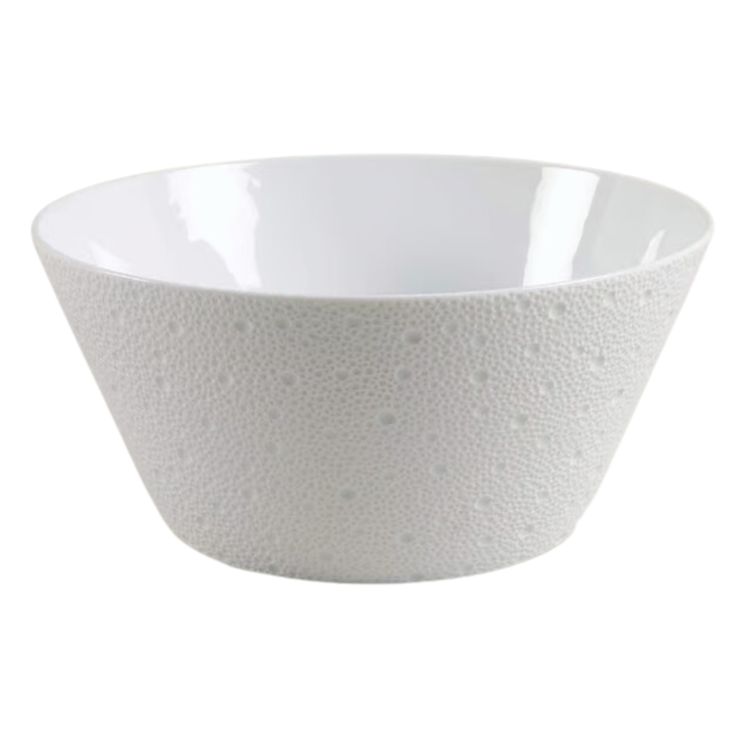 The Ecume White Dinnerware bowl by Bernardaud is crafted from white Limoges porcelain with a flared rim and dotted texture, made in France, displayed on a plain white background.