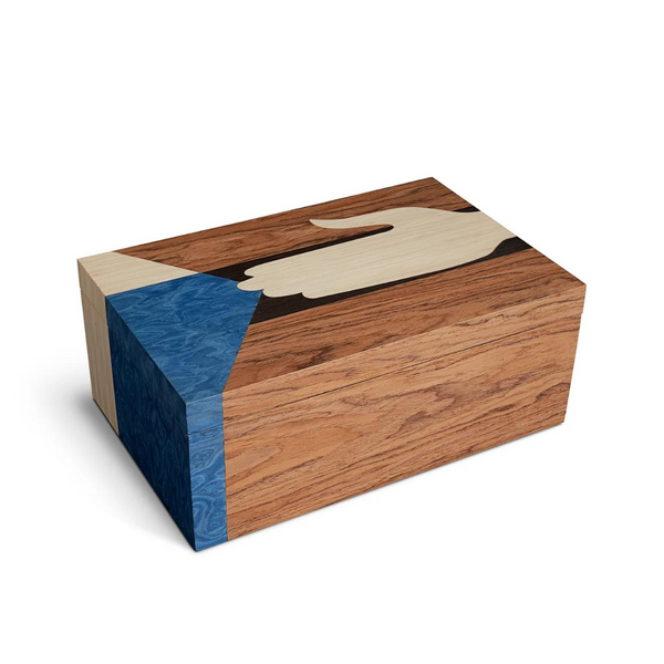 The Edgar Box by L'Objet is a rectangular marquetry box of light and dark wood with an inlaid hand holding a blue triangle on the lid and side—an elegant example of exotic wood craftsmanship.