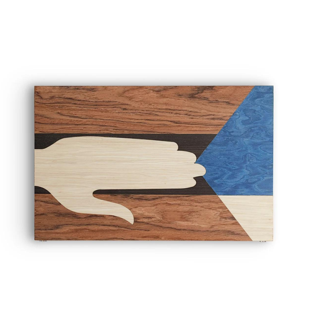 The Edgar Box by L'Objet features abstract art with a stylized beige hand pointing right, set against a textured brown, black, blue, and off-white background evoking an exotic marquetry design.
