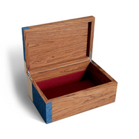 The Edgar Box by L'Objet is a marquetry box with blue-accented corners and a hinged lid that opens to reveal a red velvet-lined interior, shown against a white background.