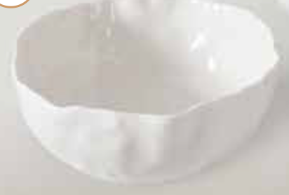 The Willow White Bowl by PAMPA BAY is a round, white ceramic bowl with an uneven, wavy rim and a matte finish, shown empty on a light surface.