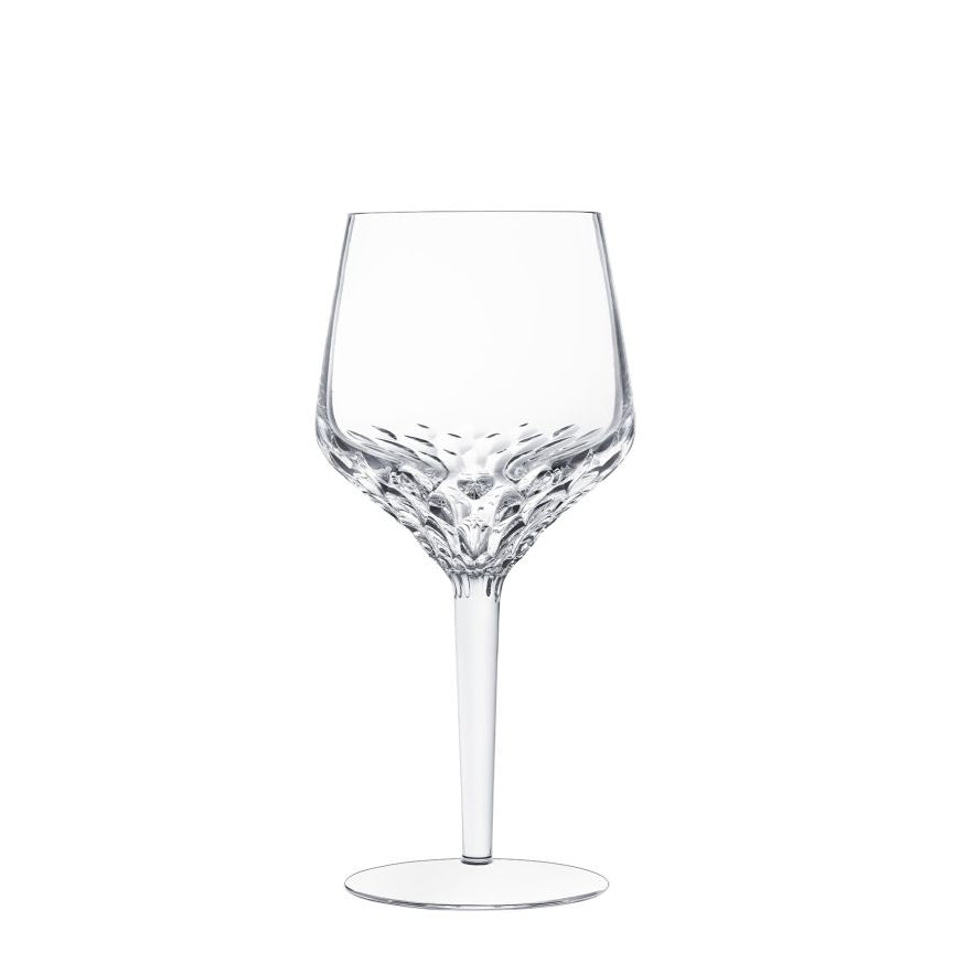 A clear Folia Stemware wine glass by Saint-Louis features a hand-cut, faceted base that tapers to a smooth stem and flat circular base, displayed against a white background.