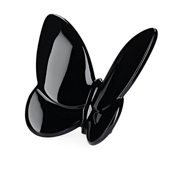 The Papilion Lucky Butterfly by Baccarat is a glossy black crystal sculpture with open wings and a minimalist design, displayed against a white background. It's perfect as an elegant gift or chic accent piece.