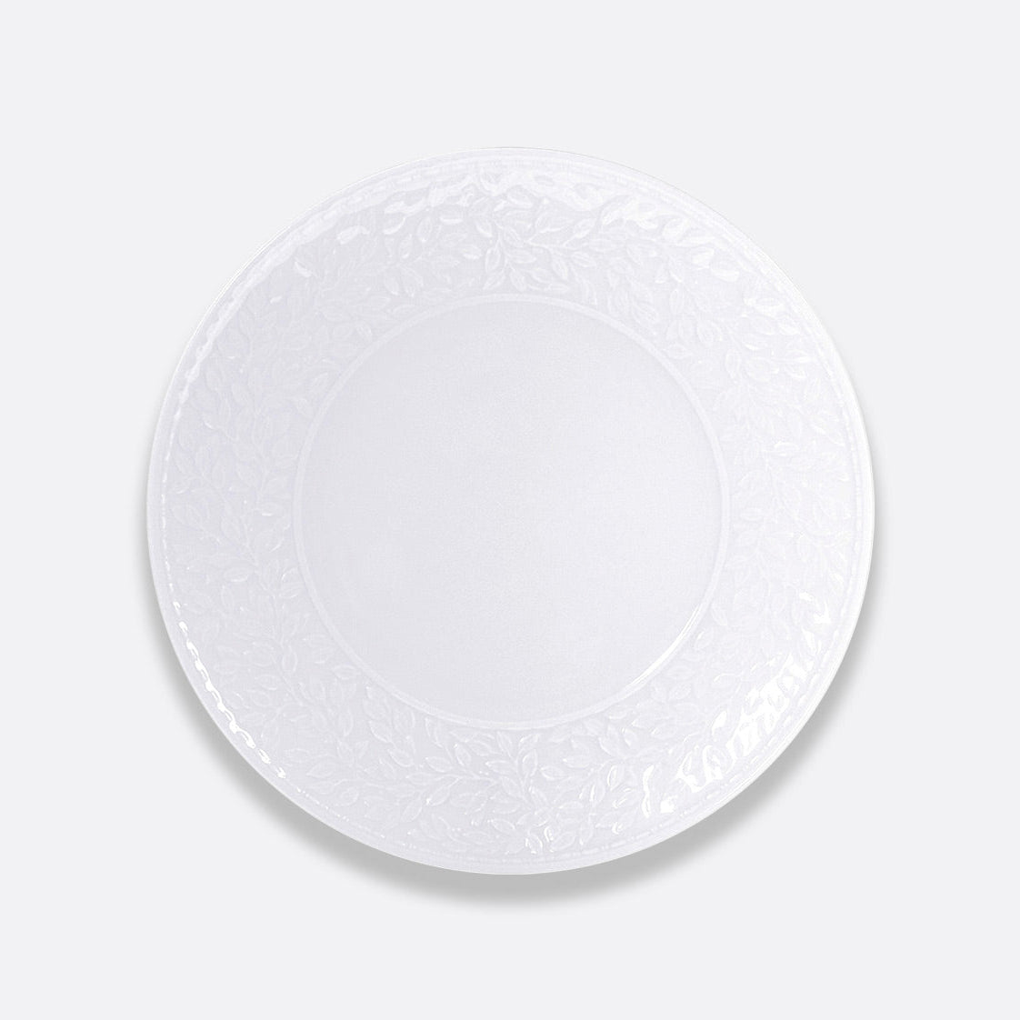 The Bernardaud Louvre Dinnerware is a round, white ceramic plate featuring a subtle Renaissance-inspired floral rim, shown on a plain light gray background.