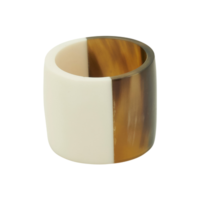 The Saro Trading Brown Horn Napkin Ring Set of 4 features wide, chunky rings with a split design—one side smooth, solid white and the other glossy brown tortoiseshell—adding modern style and organic warmth to your table. Photographed on a plain white background.