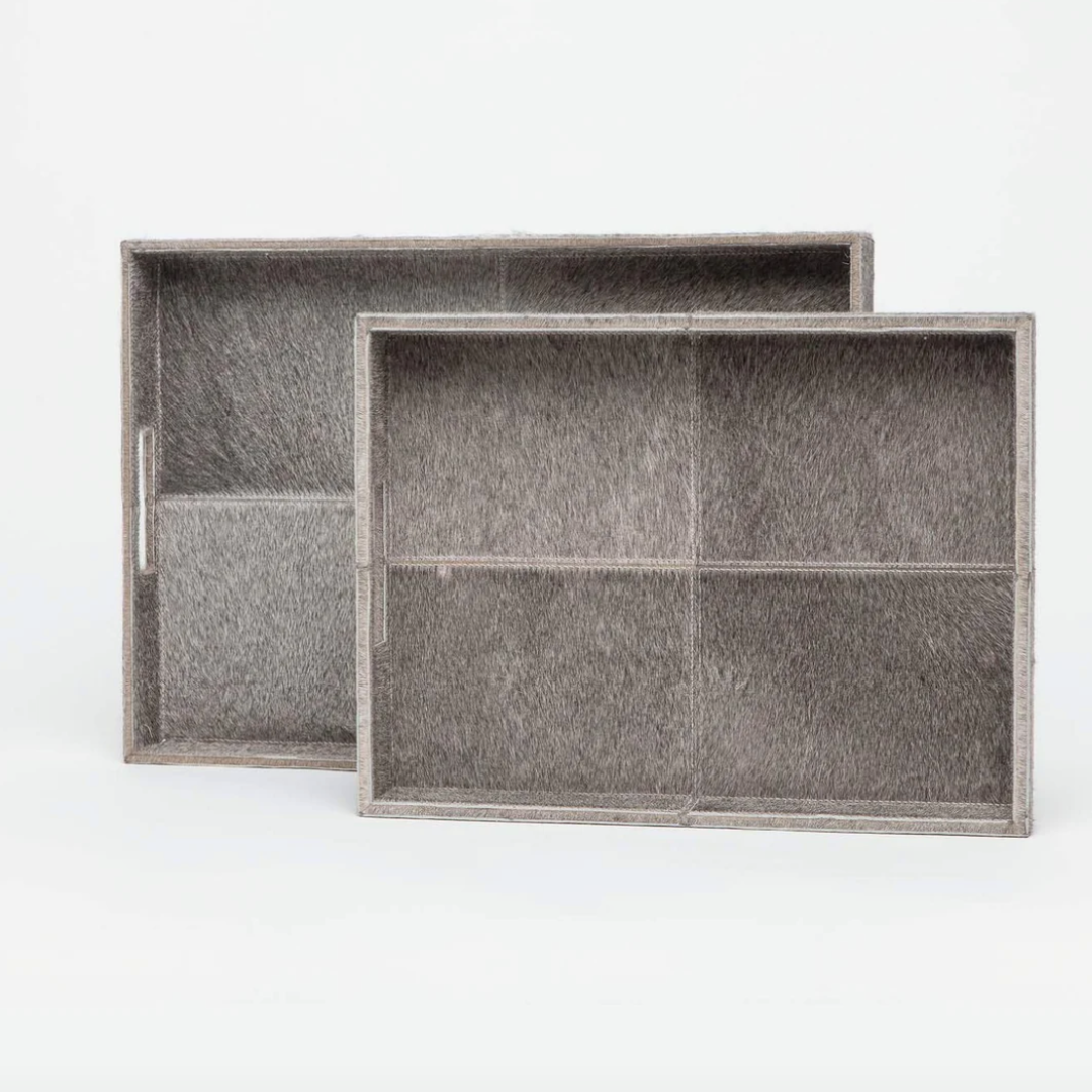 Two Made Goods Renard Rectangle Hide Grey Trays, each with four compartments and textured gray leather, are displayed on a plain white background. One tray is slightly in front of and overlapping the other.