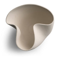 The Carmen Vase by FlowDecor Inc. is a white, asymmetrical ceramic piece with smooth curves and an abstract silhouette, featuring an irregular organic shape that casts a soft shadow on a white background.
