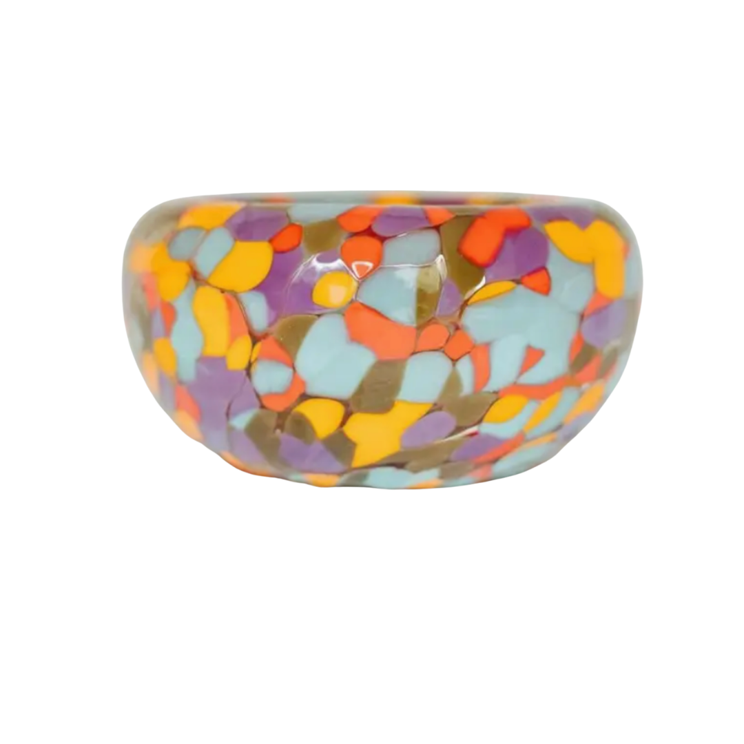 The Jester Bubble Bowl by Maria Ida Designs is a round ceramic bowl with a glossy finish, showcasing a vibrant mosaic pattern in orange, yellow, blue, purple, and red on a white background. Ideal as a jewelry catchall, this piece effortlessly blends functionality with artistic flair.