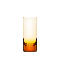 The Moser Whiskey Spirit Glass features a clear gradient design that fades from light yellow at the rim to amber orange at the base, displayed against a plain white background.