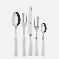 The Sabre Icone 5pps w/ Serrated Knife by Sabre features five dishwasher-safe stainless steel pieces with white handles—tablespoon, dinner fork, serrated dinner knife, salad fork, and teaspoon—arranged in a row on white.