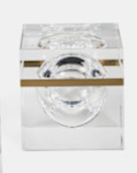 The Luho Gemma Box is a clear acrylic cube with a round, concave lens-like center and a horizontal metallic stripe, adding modern luxury to your decor.