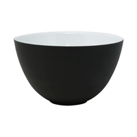 The JL Coquet Hemisphere Dinnerware Bakelite Black features a modern round bowl with a matte black exterior, glossy white interior, and is displayed on a plain white background.