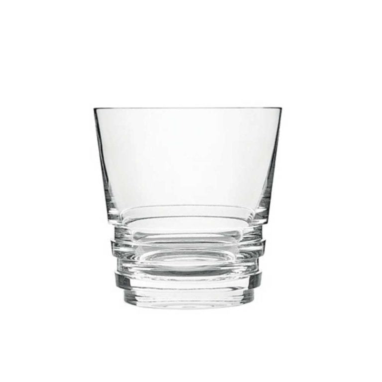 The Oxymore Drinkware by Saint-Louis is a clear glass tumbler with a wide rim, thick sturdy base, and three horizontal ridges. Its design is inspired by Saint-Louis Oxymore tumblers and photographed against a white background.
