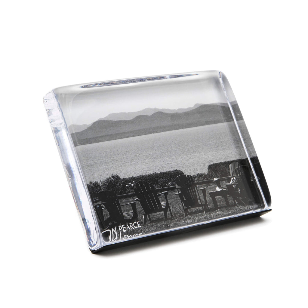 Glass paperweight with a black and white landscape print on a white background