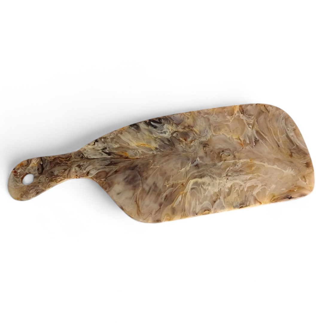 The Arila Cheese Board - Mocha by Nashi Home is a rectangular, shatterproof resin board with a handle and a marbled brown, beige, and gray finish—ideal for outdoor entertaining.
