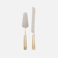 The Colson Cake Serving Set by Blue Pheasant includes a server and knife with stainless steel blades and glossy light brown handles, shown side by side on a white background—ideal for an elegant dessert presentation.