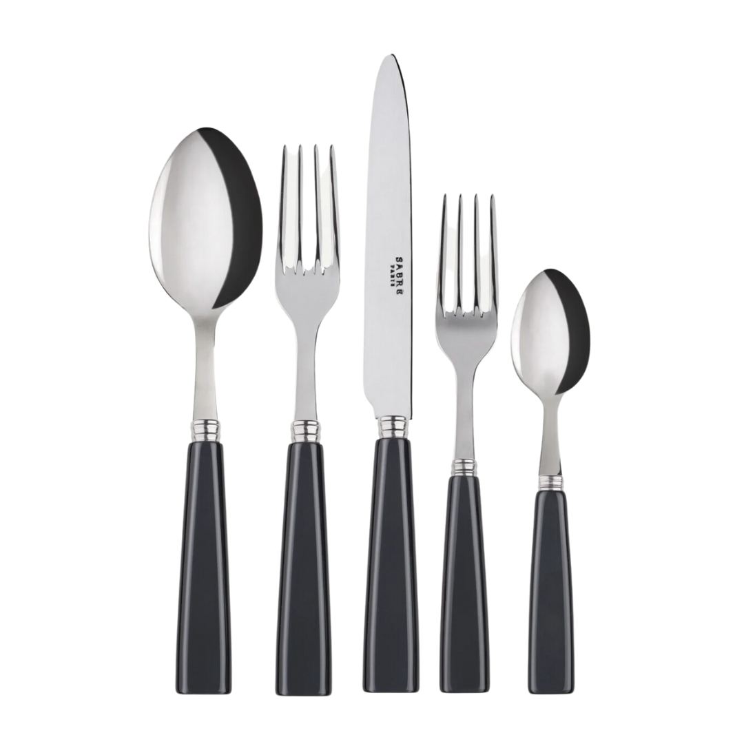 The Sabre Icone Flatware 5 Piece Setting features 18/10 stainless steel pieces with black handles—a tablespoon, dinner knife, dinner fork, salad fork, and teaspoon—displayed side by side on a white background.
