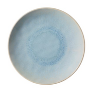 The Merritt Reactive Glaze Melamine Dinnerware Blue plate features a round shape with a light blue center, speckled darker blue ring, and pale blue-gray edge, offering a smooth texture and artisanal stoneware-inspired gradient.