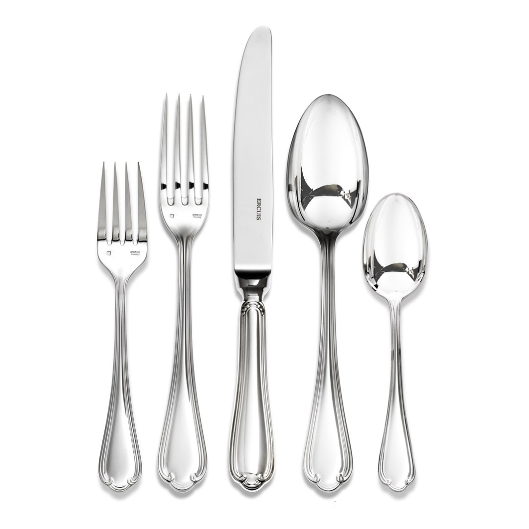 The Ercuis Sully Stainless Steel Flatware 5 Piece Setting by Ercuis includes a salad fork, dinner fork, knife, soup spoon, and teaspoon—all featuring matching ornate handles with elegant scalloped detail.