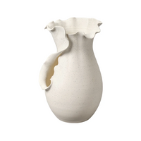 The Fabio Vase by Jamie Young is a white ceramic piece with a speckled finish and a unique ruffled, wavy rim extending down the side, giving it an artistic, handcrafted look. Set against a plain white background.